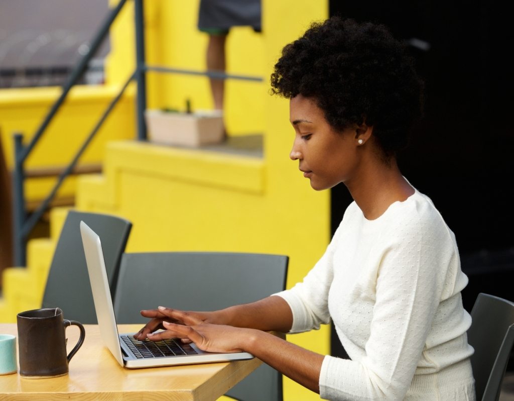 attractive-young-woman-using-laptop-outside-P9RLFGU@2x-1024x798